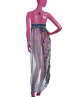 Transparent long dress with colorful details, worn by a stylized figure. The design features thin straps and a decorative top, ideal for summer and beach looks.