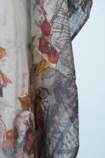 Elegant shawl made of lightweight fabric with floral and fruity patterns, featuring vibrant shades of red, yellow and gray. Perfect for a fashionable summer look.