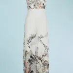 Elegant V-neck summer jumpsuit featuring a floral and geometric pattern in neutral and pastel shades, ideal for casual occasions and summer events.