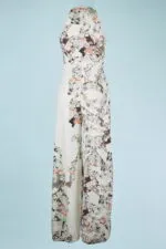 Elegant long-sleeved jumpsuit with abstract print in neutral tones and colorful details, on a light blue background. Perfect for formal events and special occasions.