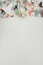 Lower part of a swimsuit with a colorful floral design and rope details, highlighting a decorative knot with multicolored beads.