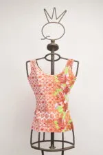 Top sans manches à l'imprimé floral et géométrique, présenté sur un mannequin en métal, idéal pour la mode estivale.