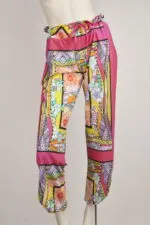 Pantaloni estivi da donna con motivo floreale colorato, realizzati in tessuto leggero e traspirante, ideali per outfit casual e da spiaggia.