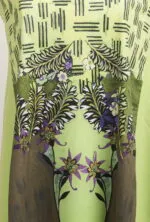 Colorful design of a light green T-shirt with floral and leaf motifs, featuring artistic details reminiscent of nature.