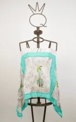Top en tissu léger avec impression de plumes colorées, présenté sur un mannequin. Un modèle idéal pour l'été, pour des tenues décontractées et cool.